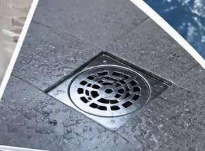 Stainless steel floor drain on a tiled bathroom floor